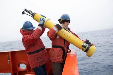 Steve Riser (left) helps deploy a float Jan. 9 that was named after climate scientist Michael Mann.