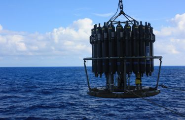 An oceanographic sampler, known as a rosette, during a 2013 cruise in the North Pacific. Each bottle contains water from different depths, which is how researchers collected samples of the vitamins at sea.