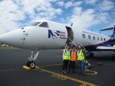 Roger Marchand with UW students Litai Kang (left) and Emily Tansey (center) in front of the Hiaper research aircraft.