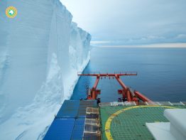 iceberg and research vessl in the southern ocean