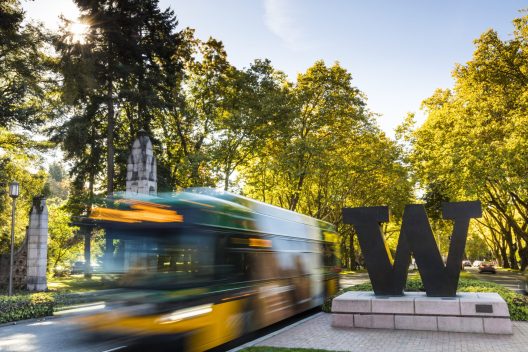 Bus driving past University of Washington's "W" sculpture on a sunny day